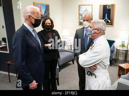 Il Presidente degli Stati Uniti Joe Biden e il Vice Presidente Kamala Harris parlano con il Coordinatore della Risposta della Casa Bianca COVID-19 Jeff Zients e il Consulente medico capo al Presidente Dr. Anthony Fauci fuori del South Court Auditorium prima di un evento che celebra il 50 milionesimo vaccino COVID-19 nell'edificio Eisenhower Executive Office di febbraio 25, 2021 a Washington, D.C. Foto Stock