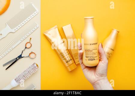 L'oreal professionnel Paris Serie Expert loreal nutriente per capelli prodotti professionali Set forbici pettini e utensili per parrucchieri. Shampoo LOREAL in mano Foto Stock