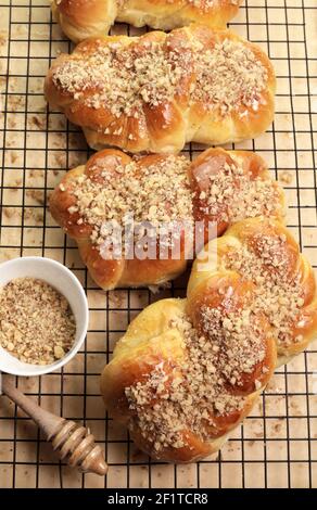 Cucina rumena. Mucenici fatti in casa, dolci tradizionali fatti nella figura 8 per apparire come garlands, cosparsi di miele e noci tritate. Foto Stock