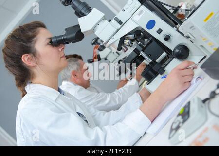 tecnico medico che fa osservazioni Foto Stock