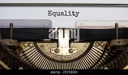 Simbolo dell'inclusione e dell'uguaglianza. La parola 'uguaglianza' digitata su una macchina da scrivere retrò. Concetto di economia, inclusione e uguaglianza. Splendido sfondo. Foto Stock