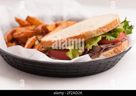 panino di manzo arrosto fatto in casa su pane di pasta frolla con croccante patatine fritte Foto Stock