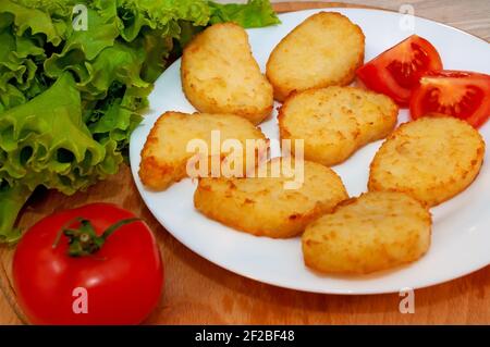 Frittelle di patate al forno e pomodoro Foto Stock