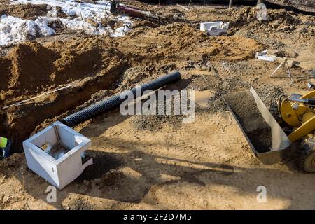 Costruzione installata di tubo di calcestruzzo di sistema di drenaggio su cui lavorare la strada per fognature di acqua drenata Foto Stock