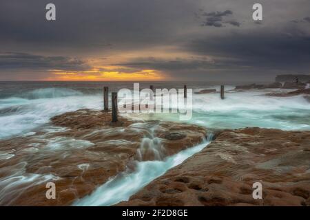 South Coogee rock pool che scorre acqua all'alba, South Coogee, Sydney, NSW, Australia Foto Stock
