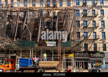 I lavoratori hanno decostruito i ponteggi nel quartiere Chelsea di New York mercoledì 24 febbraio 2021. (© Richard B. Levine) Foto Stock