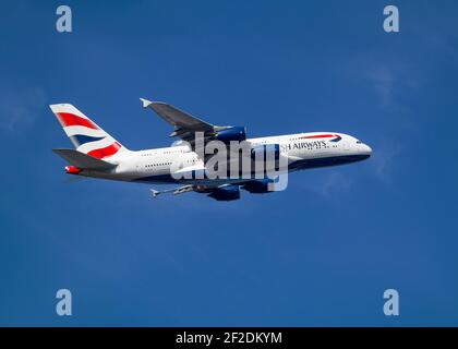 londra, Aeroporto di Heathrow - Aprile 2019: British Airways Airbus A380 che vola attraverso un cielo blu catturato dal lato. Immagine Abdul Quraishi Foto Stock