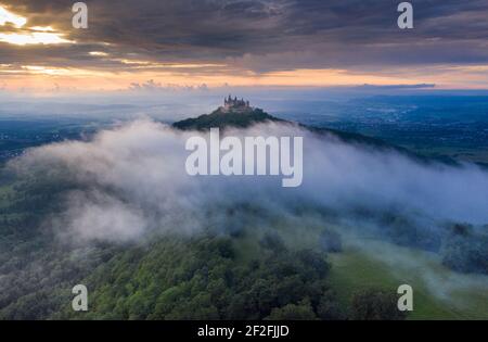 Castello di Hohenzollern nella nebbia al tramonto, Germania Foto Stock