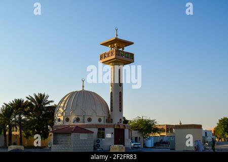 Una piccola vecchia moschea circondata da palme da dattero Foto Stock