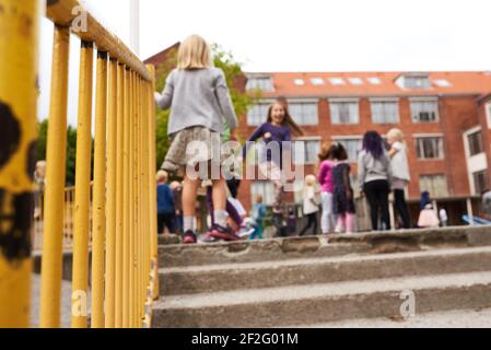 Bambini che giocano nel parco giochi a scuola Foto Stock