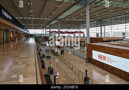 12 marzo 2021, Brandeburgo, Schönefeld: Vista sul terminal 1 dell'aeroporto della capitale Berlino Brandeburgo "Willy Brandt" (BER). Nel pomeriggio si terrà una riunione del Consiglio di sorveglianza della Flughafen Berlin-Brandenburg GmbH. L'argomento principale sarà i futuri requisiti finanziari dell'azienda. La società di gestione conta sulla riduzione parziale del debito da parte degli stati di Berlino, Brandeburgo e governo federale. Foto: Patrick Pleul/dpa-Zentralbild/ZB Foto Stock