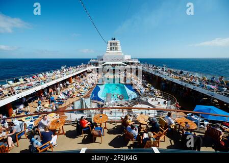Passengers in the afternoon on the deck of a cruise ship Foto Stock