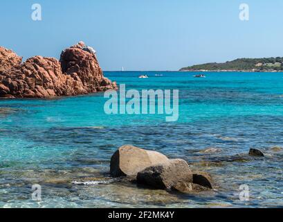 Le rocce rosse sul bordo settentrionale della lunga spiaggia chiamata Spiaggia di Cea, nei pressi di Arbatax (Sardegna, Italia) Foto Stock