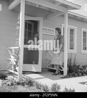 Contea di Tulare, Farmersville, California. Campo di gestione della sicurezza agricola (FSA) per i lavoratori agricoli migratori. Accesso alla clinica di Medicina e Salute dei lavoratori agricoli (FSA) per l'aiuto dell'infermiere con il bambino malato. La donna anziana dice: "Sono solo un vicino e mi dispiace davvero per loro". Maggio 1939 . Fotografia di Dorothea Lange. Foto Stock