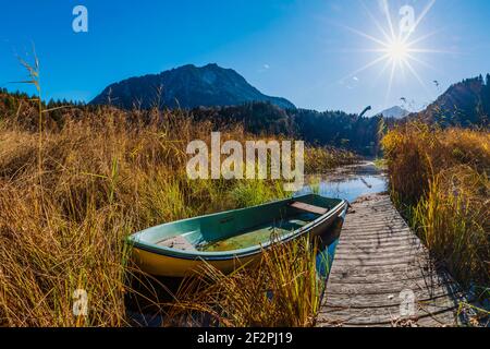 Barca a remi su Freibergsee, alle sue spalle il salto con gli sci Heni-Klopfer, le Alpi di Allgäu, Allgäu, Baviera, Germania, Europa Foto Stock