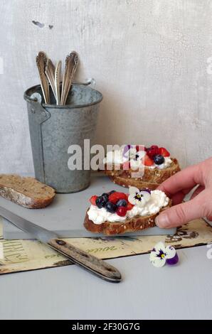 Pane granaio con formaggio cremoso e insalata di frutti di bosco estivi Foto Stock
