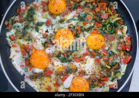 Nel corso della preparazione della colazione con uova fresche e. verdure Foto Stock