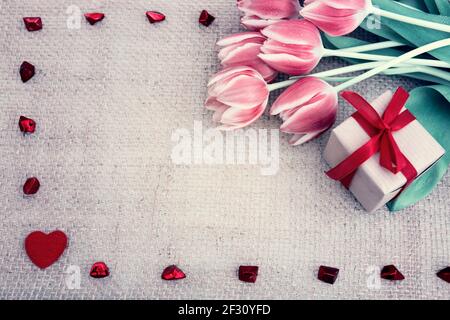San Valentino con tulipani e cuore rosso su tessuto sfondo. Foto Stock