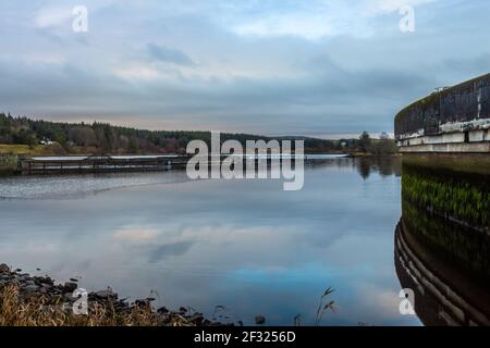 Deugh Dam e allevamento ittico a Kendoon Loch, al tramonto in inverno vicino a Carsphairn, Dumfries e Galloway, Scozia Foto Stock