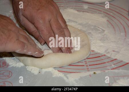 Pizza chef privato che prepara l'impasto crudo della pizza nel cucina Foto Stock