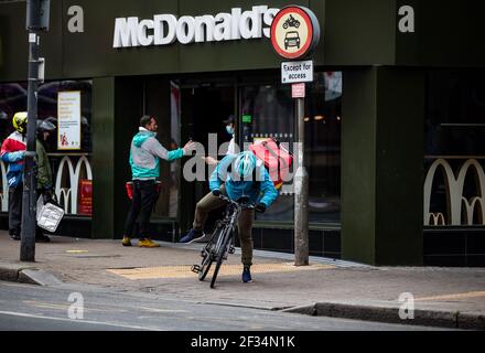 Consegna piloti in attesa al di fuori di McDonald’s a Tooting, South London, in attesa di collezioni alimentari. Dopo l’offerta di McDonald’s consegna via Uber eats dal 15 Foto Stock