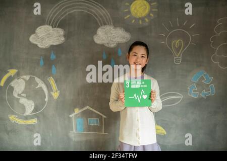 Ragazza che ha un'icona SDG Foto Stock