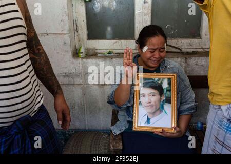 Una donna in lacrime fa il saluto a tre dita mentre tiene un ritratto del suo parente sparato morto un giorno prima dalle forze di sicurezza dopo che hanno aperto il fuoco verso pacifici manifestanti militari colpo di stato in Yangon.Myanmar polizia ha attaccato i dimostranti con proiettili di gomma, munizioni vive, Lacrima di gas e bombe stordite in risposta ai manifestanti anti anti anti-colpo di stato militari domenica, uccidendo oltre 70 manifestanti e ferendo molti. L'esercito del Myanmar ha arrestato il consigliere di Stato del Myanmar Aung San Suu Kyi il 01 febbraio 2021 e ha dichiarato uno stato di emergenza mentre cogliendo il potere nel paese per un anno dopo aver perso il Foto Stock