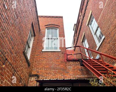 Wayesboro, GA USA - 02 11 21: Vecchio edificio in mattoni facciata vacanza luci vintage finestre e scale Foto Stock