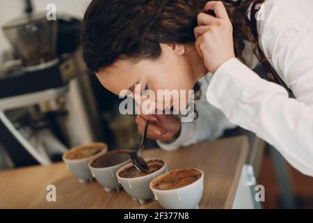 Tazza degustazione ragazza degustazione Degostation caffè prova di qualità. Tazza di caffè. Foto Stock