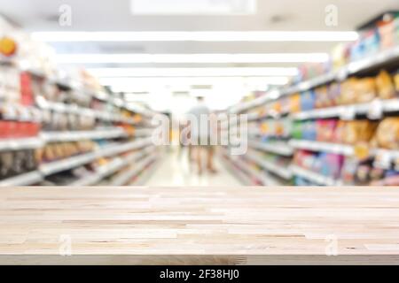 Tavolo in legno su sfondo blur supermercato - può essere utilizzato per la visualizzazione o il montaggio dei prodotti Foto Stock