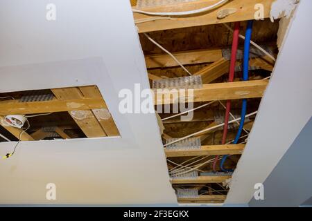 Tubo idraulico nel servizio di riparazione, riparando il soffitto danneggiato che perde Foto Stock