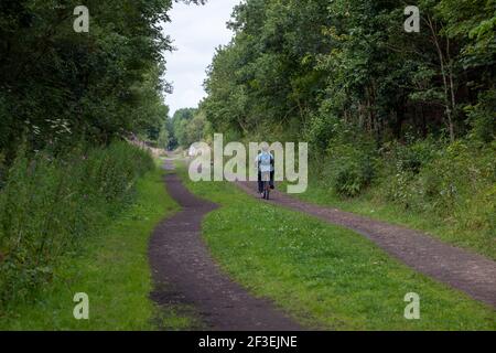 Vista estiva di un ciclista che corre lungo la Trance Pennine Percorso ciclabile nei pressi di Penistone nel South Yorkshire Foto Stock