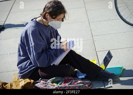 Studente italiano prende lezioni di apprendimento a distanza per strada in protesta della chiusura della scuola di Covid Torino, Italia - Marzo 2021 Foto Stock