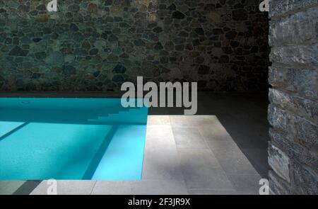 Piscina interna con pietra circondano Foto Stock