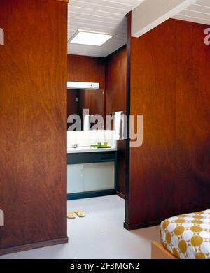 View through wood panelled doorway to en suite bathroom, USA Stock Photo
