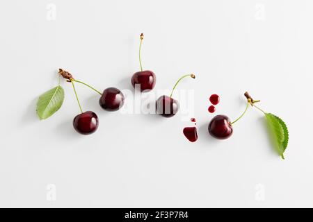 Mazzetto di ciliegie fresche con foglie su un tavolo Foto Stock