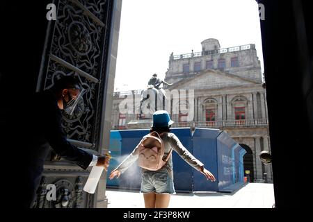 Non esclusivo: CITTÀ DEL MESSICO, MESSICO - MARZO 16: Un operaio spruzza disinfettante a una persona prima di entrare al Museo Munal, in mezzo all'allarme arancione di Covid Foto Stock