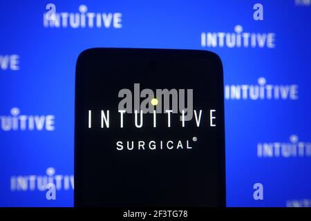 In questa illustrazione fotografica, sullo schermo di uno smartphone e di un pc viene visualizzato un logo chirurgico intuitivo. Foto Stock