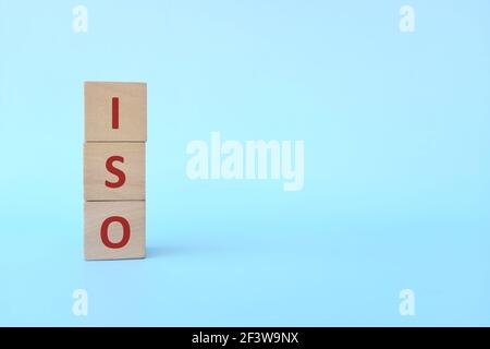 Acronimo ISO o Organizzazione Internazionale per la standardizzazione su blocchi di legno su sfondo blu. Foto Stock