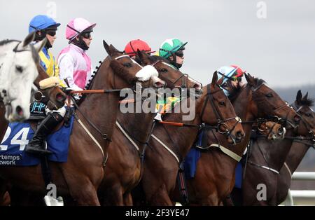 Corridori e piloti si riuniscono per l'inizio del Pertemps Network Final handicap hurdle durante il terzo giorno del Cheltenham Festival all'ippodromo di Cheltenham. Data immagine: Giovedì 18 marzo 2021. Foto Stock