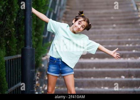 Ragazza di nove anni che gioca con una lampada da strada in un parco. Ragazza di nove anni che gioca con una lampada da strada Foto Stock