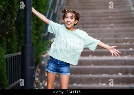 Ragazza di nove anni che gioca con una lampada da strada in un parco. Ragazza di nove anni che gioca con una lampada da strada Foto Stock