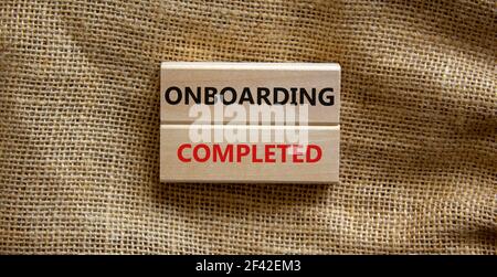 Simbolo di inserimento completato. Blocchi di legno con le parole 'Onboarding completed'. Splendido sfondo in tela. Business, onboarding completed concept, COP Foto Stock