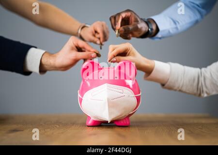 Business Crowdfunding e Corona Covid Piggy Bank Foto Stock