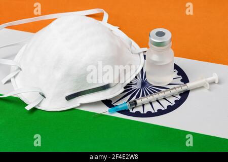 Flag India, maschera facciale N95, siringa per ago e flaconcino. Concetto di distribuzione del vaccino del coronavirus Covid-19, carenza di approvvigionamento e crisi sanitaria Foto Stock