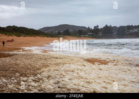 Avalon Beach, Sydney, Australia 21 marzo 2021.As inondazioni battter nuovo Galles del Sud la costa orientale surf batte la costa. Lady cammina attraverso il seaf Foto Stock