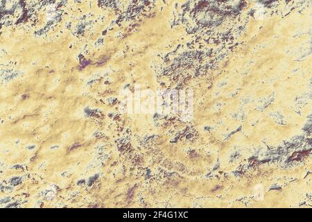 Un primo piano di una superficie rocciosa gialla resistente alle intemperie Foto Stock