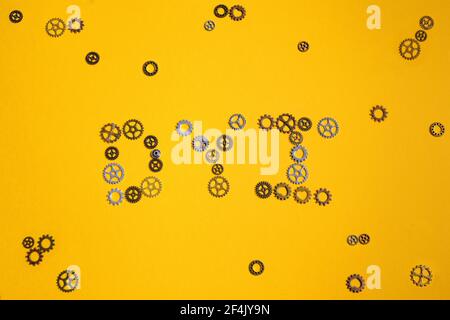 Abbreviazione DYI composta da ingranaggi su sfondo giallo. Concetto DIY Foto Stock
