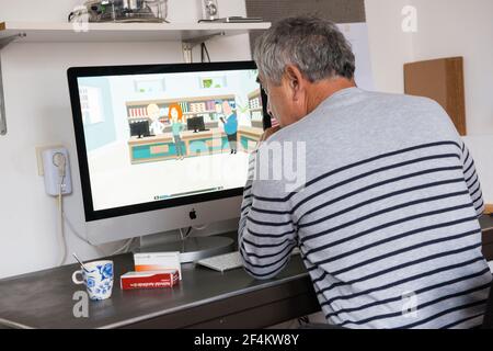 Tilburg, Paesi Bassi. Oudere man bekijkt online de Animaties van Kijksluiter na het kopen en hafhalen van kijnen bij de Apotheek. Tilburg, Paesi Bassi. Uomo che guarda le animazioni online di Kijksluiter, appena dopo l'acquisto e la raccolta di scatole di nuovi farmaci. Foto Stock