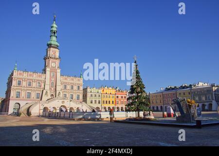 Zamosc, Polonia, 27 dicembre 2020. Albero di Natale decorato sulla piazza di fronte al municipio in una gelida mattina d'inverno. Antichi archi europei Foto Stock